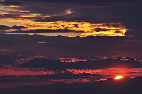 black sky and orange clouds during sunset thumbnail