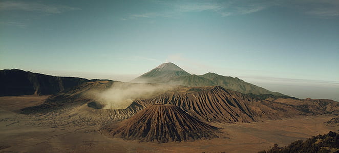 brown volcano under cloudy sky during daytime thumbnail