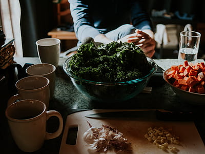 bowl of broccoli beside bowl of carrot cubes and chopping board thumbnail