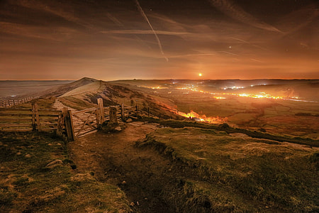 landscape photo of mountain with brown wooden fences and flame on the ground thumbnail
