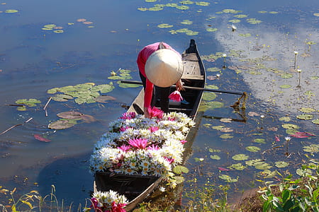 person wearing white hat standing on boat thumbnail