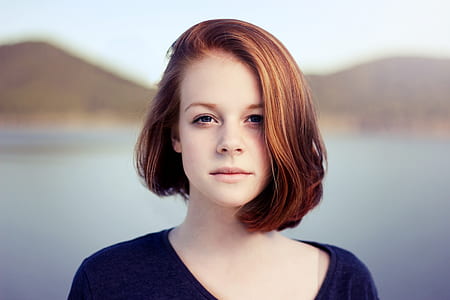woman wearing black scoop-neck top near body of water thumbnail