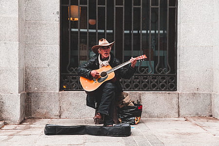 man playing guitar in street thumbnail