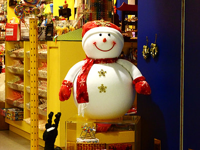 snowman statue on glass-top table beside shelf thumbnail