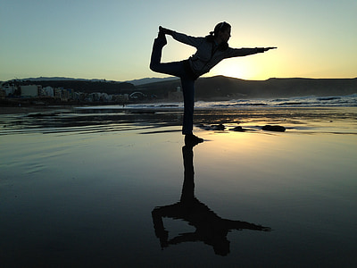 silhouette of woman doing exhibition beside body of water thumbnail