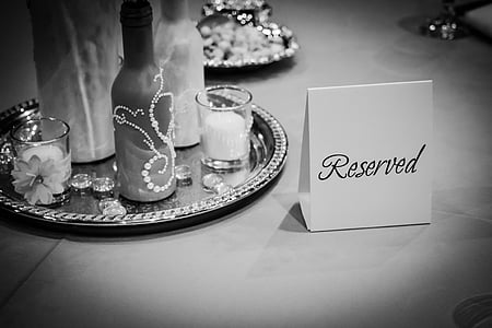 grayscale photo of reserved sign on table thumbnail
