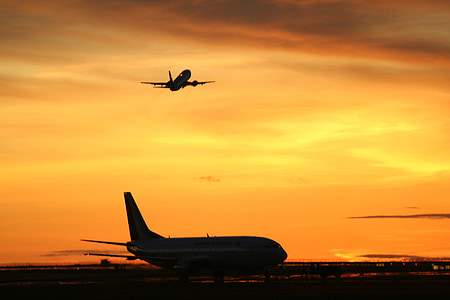silhouette of two airbuses at sunset thumbnail
