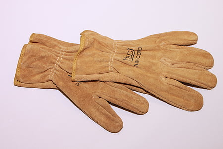 pair of brown gloves on white surface thumbnail