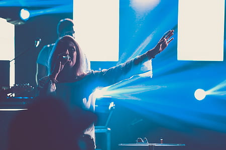 shallow focus photography of woman performing on stage thumbnail