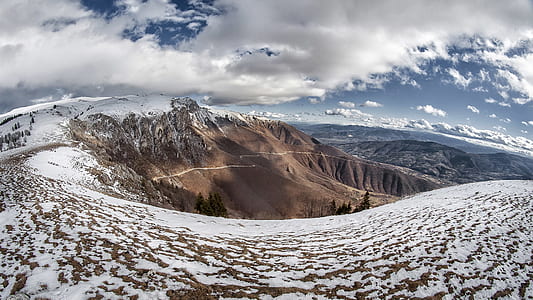 Landscape Photo of Snowy Mountain Under Cloudy Sky thumbnail