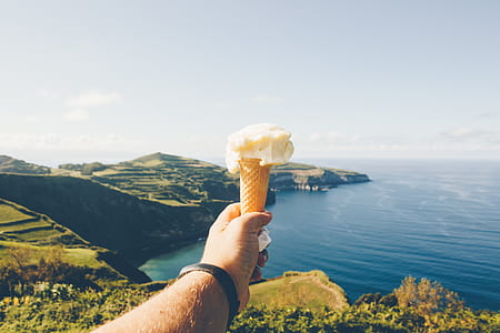 person holding ice cream cone thumbnail