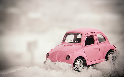 pink Volkswagen Beetle compact car die-cast selective focus photography thumbnail