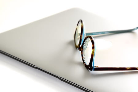 tortoiseshell framed eyeglasses on silver MacBook thumbnail
