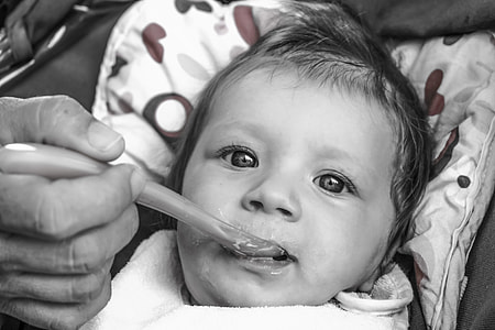 close-up grayscale photo of baby thumbnail
