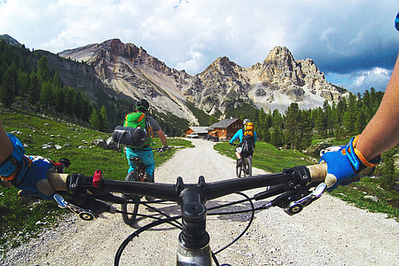 A  man riding on a bicycle in mountains thumbnail