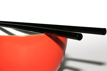 two black sticks on red bowl thumbnail
