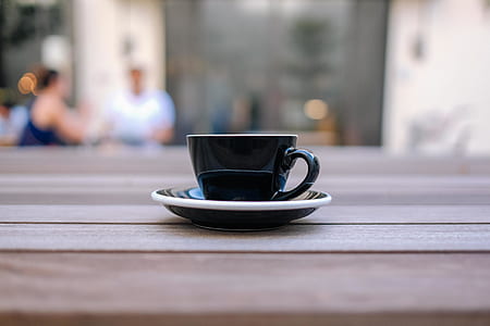 black cup and saucer on brown panel thumbnail