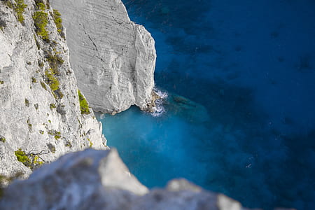 white rock cliff near ocean thumbnail