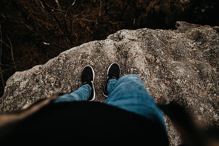 person standing on gray rock thumbnail