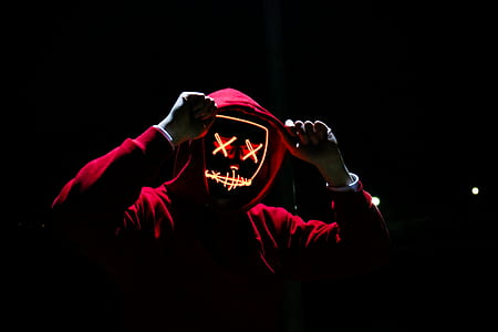 person wearing red hoodie and neon mask thumbnail