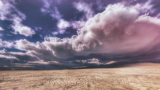 desert during blue and cloudy day thumbnail