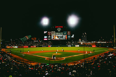 open lighted baseball stadium during nighttime thumbnail