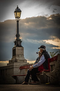 man and women sitting on bench during sunset thumbnail