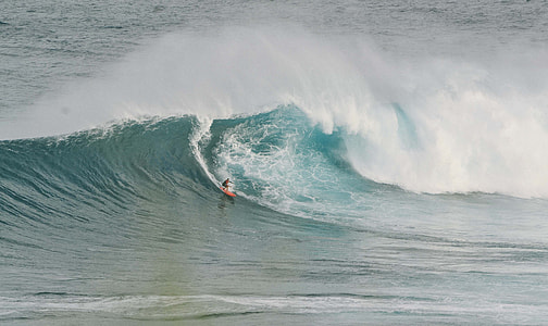 sea waves with surfer during daytime thumbnail