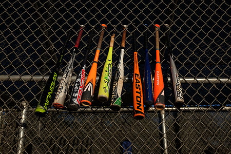 assorted baseball bats placed on gray welded wire sheet thumbnail