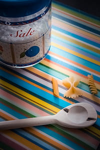 White Wooden Serving Spoon on Multicolored Textile thumbnail