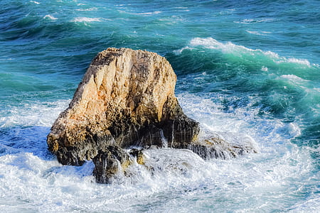 gray rock on body of water at daytime thumbnail