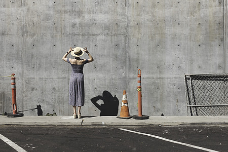 woman wearing white sunhat and gray dress thumbnail