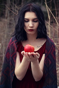 woman in red top holding apple during daytime thumbnail