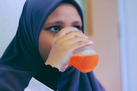 woman drinking on plastic cup thumbnail