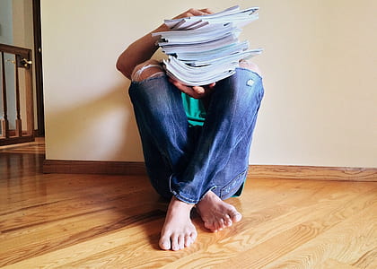 person sitting holding books thumbnail
