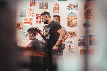 man wearing black crew-neck T-shirt while holding black hair trimmer thumbnail