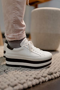 A woman in white flatform sneakers thumbnail