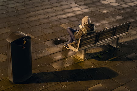 person sitting on bench near box thumbnail
