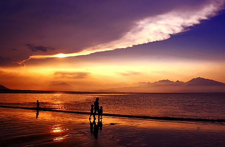 silhouette photo of four person near seashore thumbnail