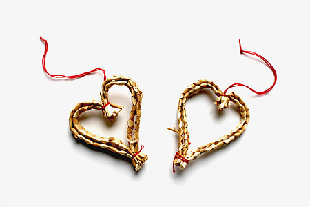 two heart-shaped brown pendant necklaces on white textile thumbnail