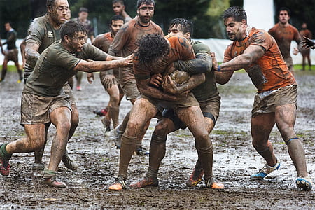 people playing football on mud thumbnail