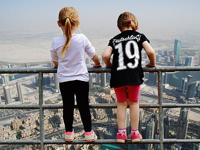 two girls standing on railings thumbnail