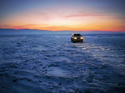 Black Suv on Snow during Golden Hour thumbnail