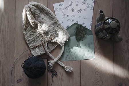 gray knit hat on brown wooden surface thumbnail