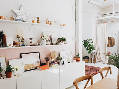 two white floating shelves and white wooden cabinet on white wall thumbnail