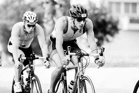 graycale photo of two men riding bicycles thumbnail