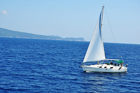 photo of white sailboat on blue sea during daytime thumbnail