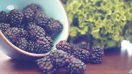 black berries in white ceramic bowl on brown surface thumbnail