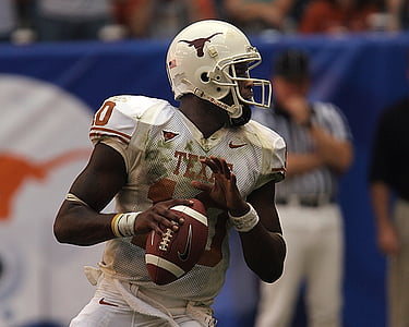 Texas Longhorn player holding football ball photography thumbnail