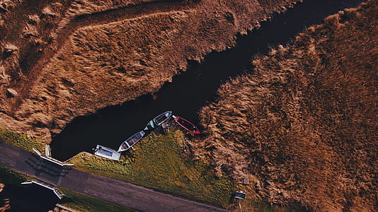 aerial photo of four boats on river during daytime thumbnail
